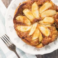 Air Fryer German Apple Pancakes Overhead Shot on a white platter with a fork on the side