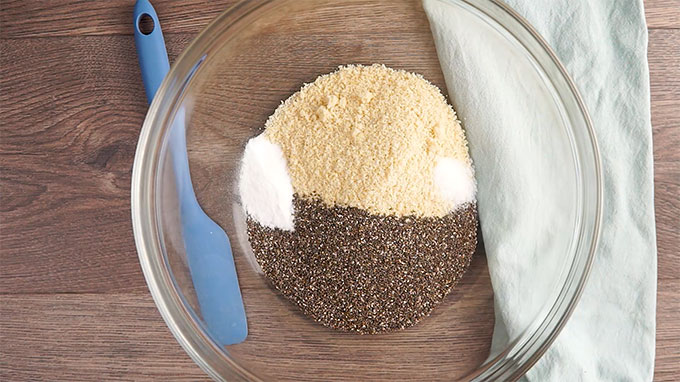 Almond flour, chia seeds, baking soda, and salt in a glass bowl. 