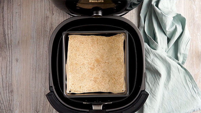 Pie crust in a glass baking dish placed in an Air Fryer