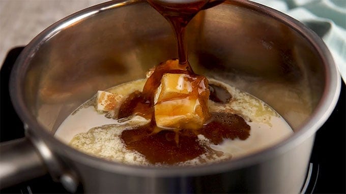 Butter, sugar, and maple syrup melting in a saucepan on a stovetop