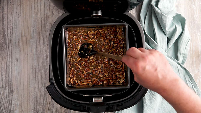 Pecan filling spread in a glass baking dish in the air fryer 