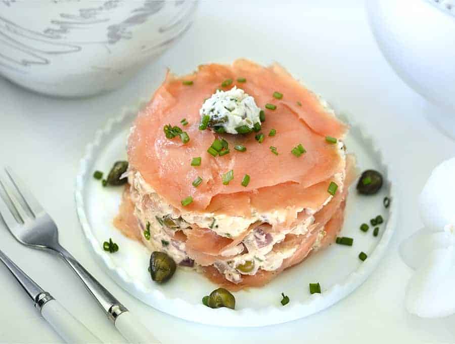 Smoked Salmon Timbale garnished with chives on a white platter