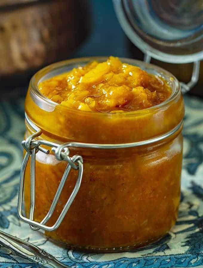 A closeup of Peach and Ginger Chutney in a jar.