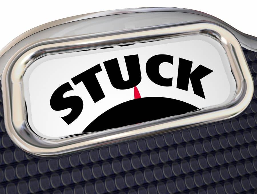 A closeup of a scale with the word STUCK.