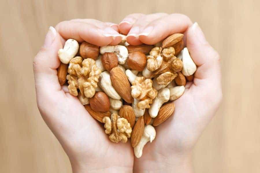 nuts and seeds in the palm of a hand