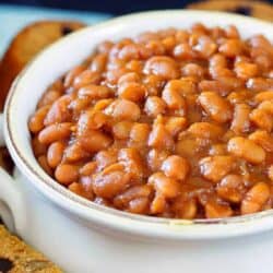 Close up image of Instant Pot baked beans served in a white bowl