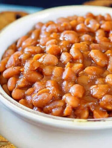 Close up image of Instant Pot baked beans served in a white bowl