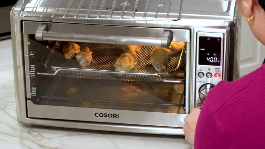 Side shot of broiling the chicken wings in the oven.