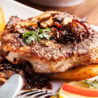 Fried pork chop with mushrooms and chips