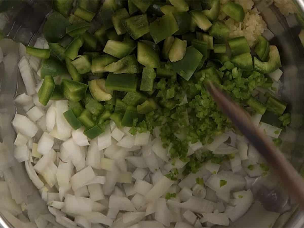 chopped onions, bell pepper and jalapeno in the bottom of the Instant Pot liner