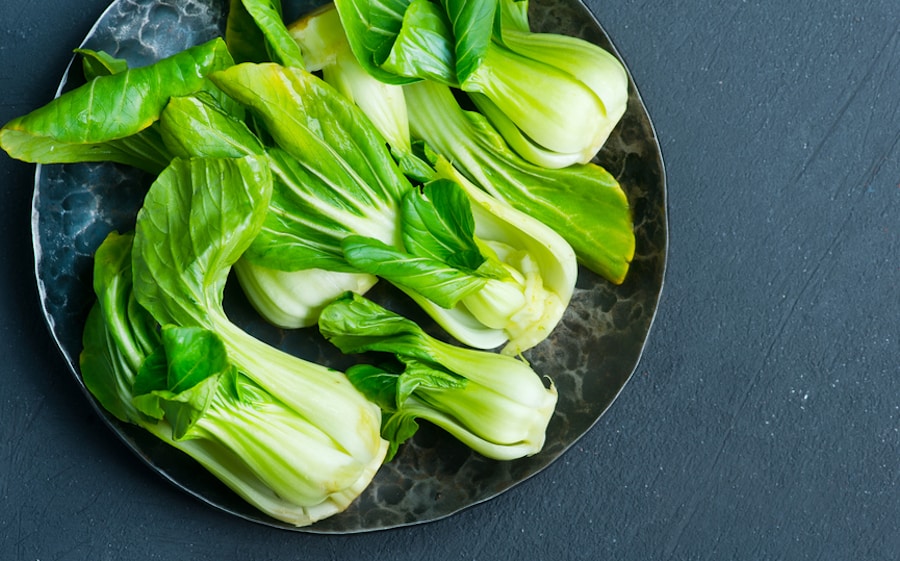 baby bok choy on a plate against blue background