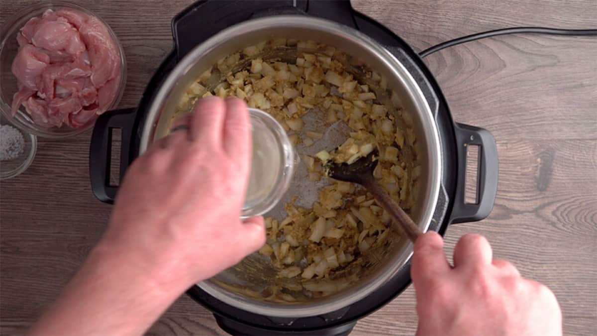 cooking chopped onions with curry paste in an instant pot