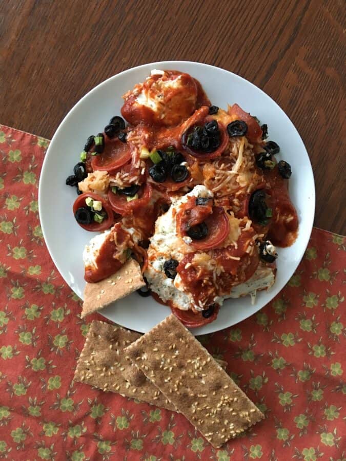 Keto pizza casserole on a plate served with crackers