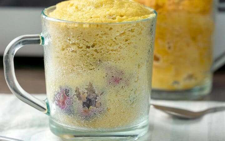 A mug cake in a glass mug ready to eat