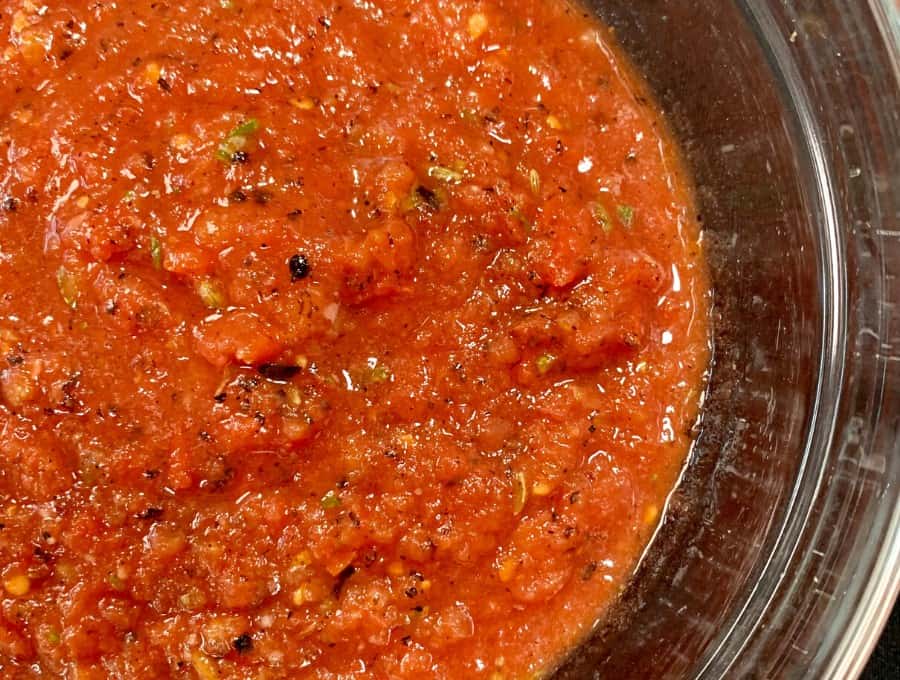 Overhead image of keto pizza sauce in a glass bowl.