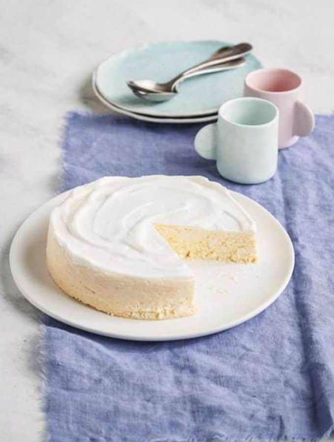 Ricotta Cheesecake with a slice removed on a white plate
