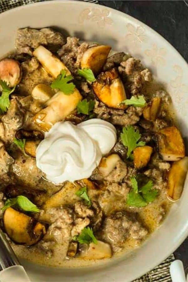 Low Carb Beef Stroganoff served in a white bowl and topped with sour cream
