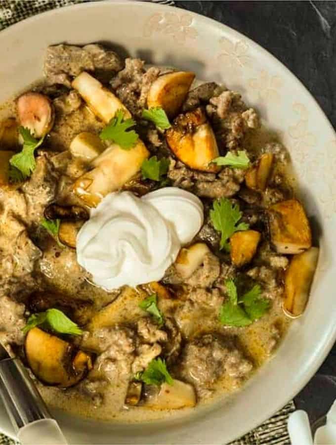 Low Carb Beef Stroganoff served in a white bowl and topped with sour cream