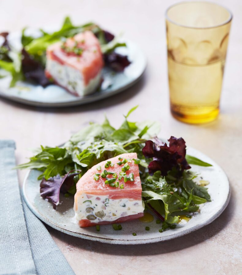 Smoked Salmon Appetizer Served on a rustic plate with a side salad.