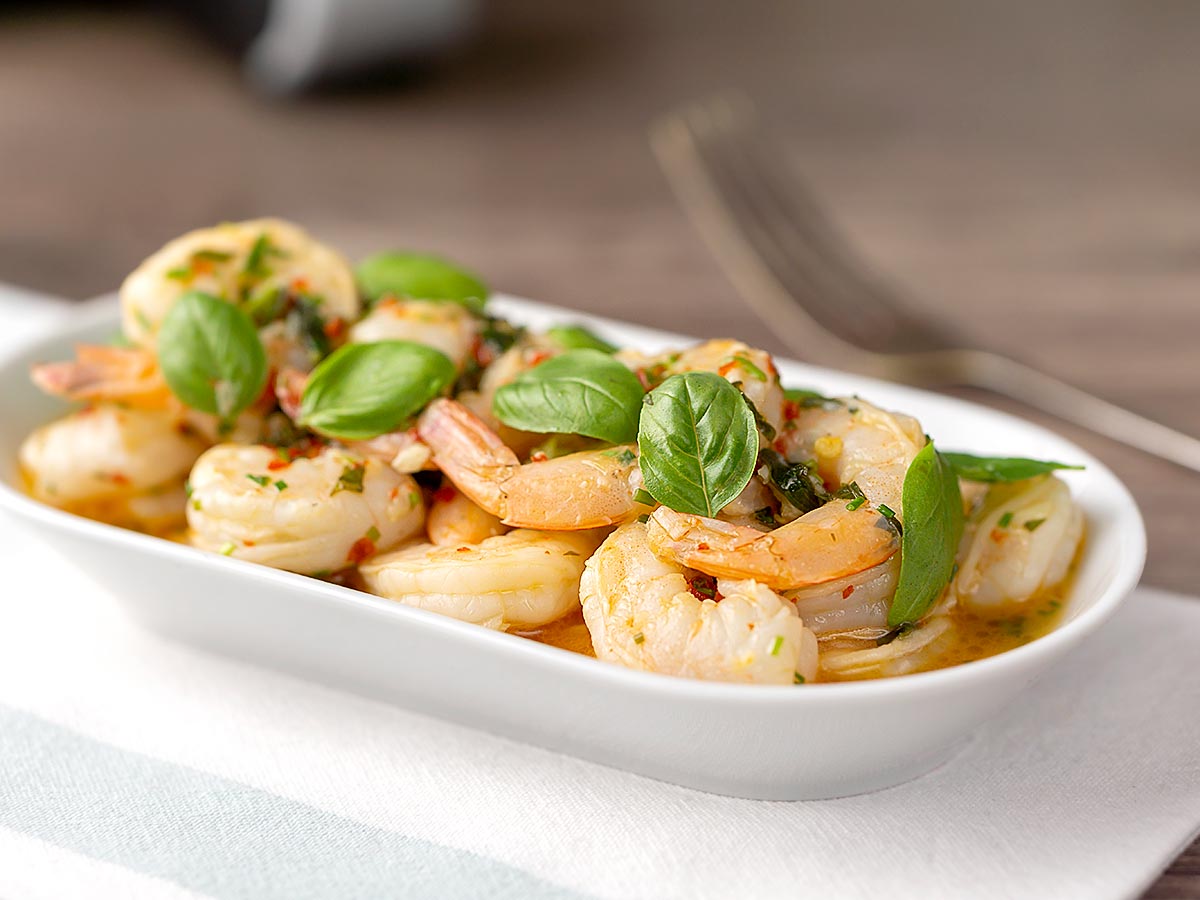 Air Fryer Shrimp Scampi served in a white bowl on a white table cloth