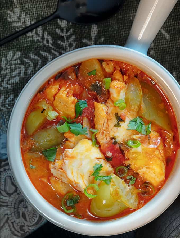 Brazilian Moqueca Fish Stew served in a white bowl with a handle.