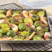 Overhead image of brussel sprouts with bacon on a cooling rack.