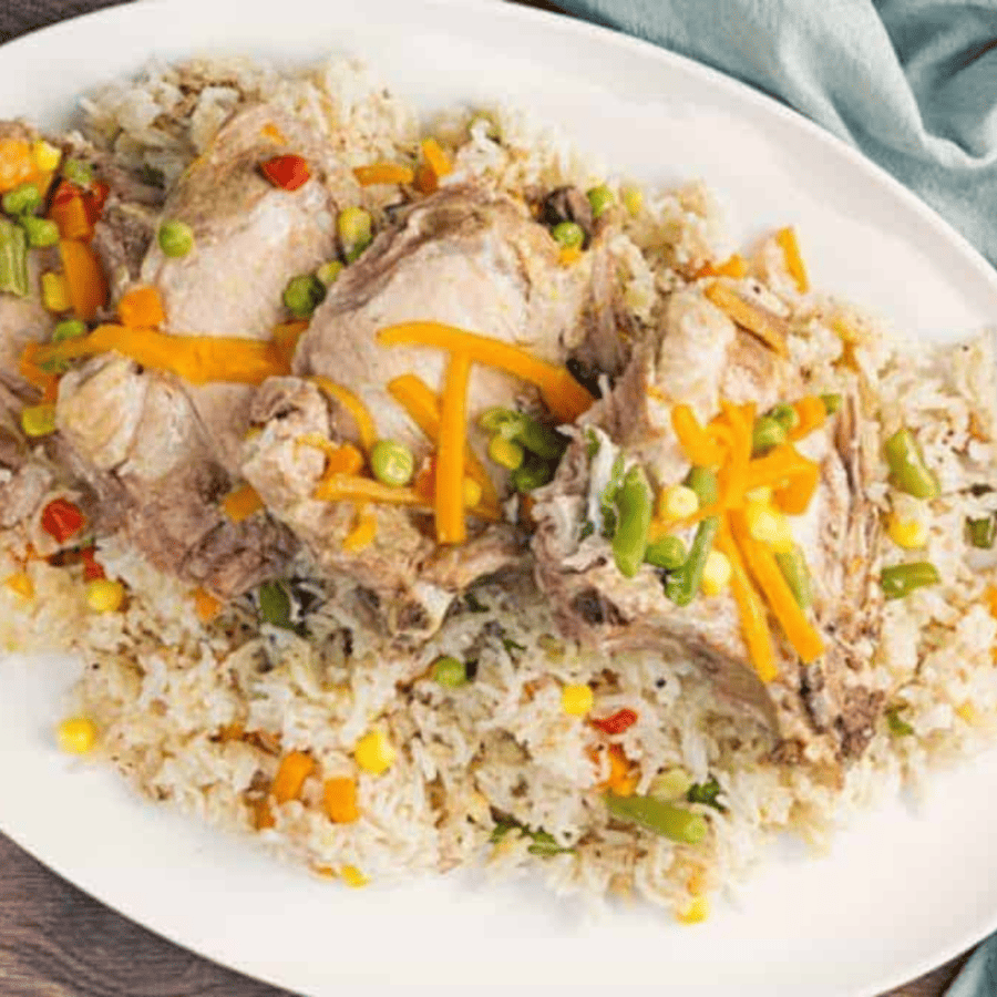 Overhead image of Instant Pot Pork Chops and Rice on a white platter