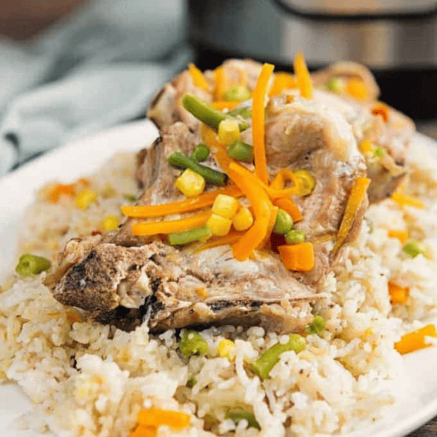 Instant Pot Pork Chops and rice on a white plate