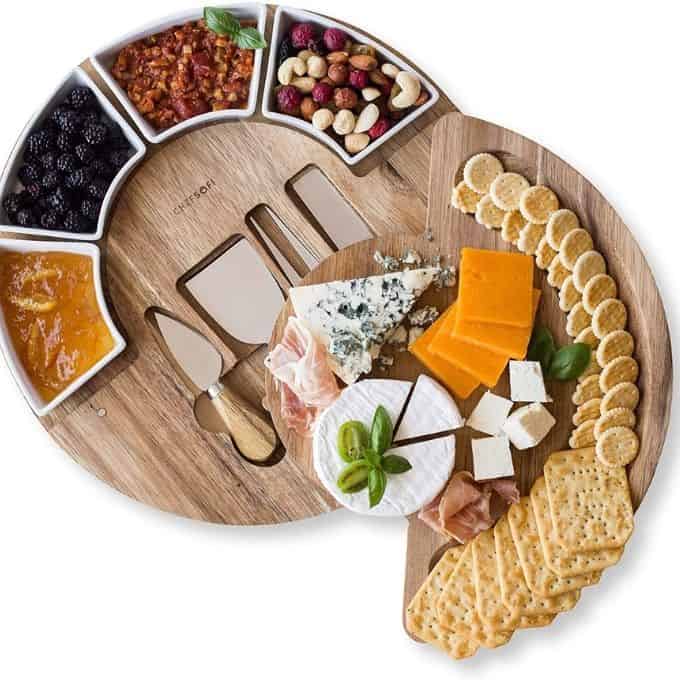 circular charcuterie tray with serving utencils