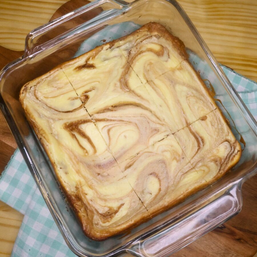 Keto Cheesecake brownies cut into 9 pieces in a glass baking pan