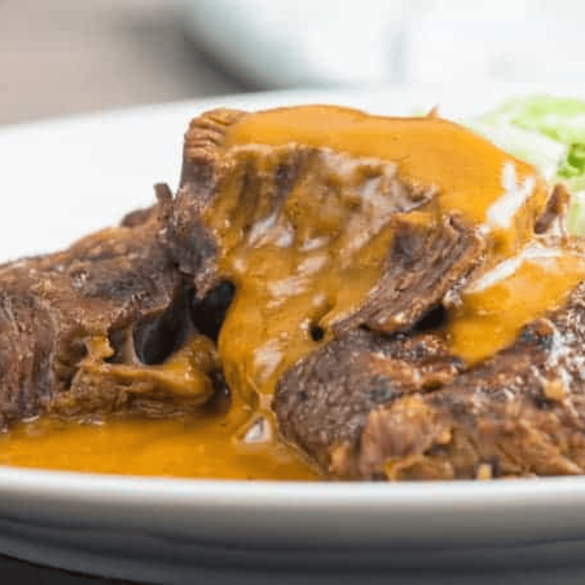 Close up image of Instant Pot Brisket on a white plate