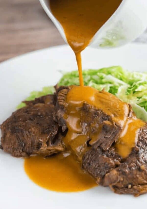 Sauce being poured over the top of Instant Pot Brisket