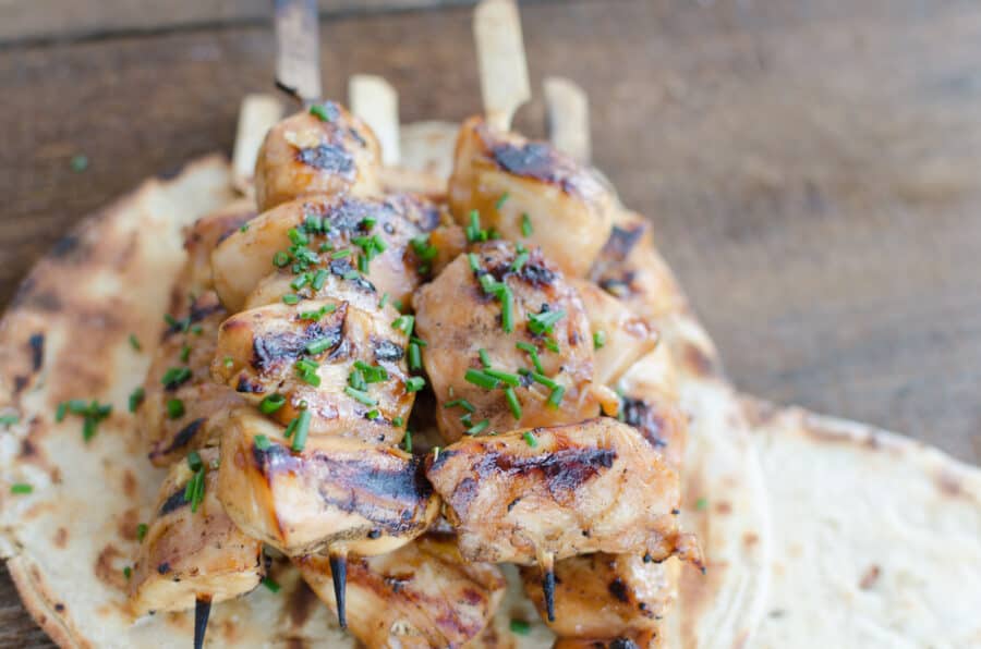 Air Fred Chicken Tenderloins on a skewer served on naan