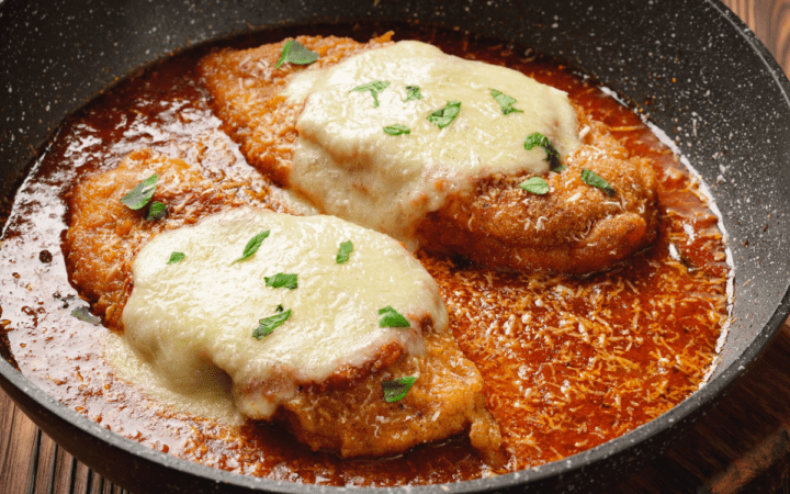 Keto Chicken Parmesan in a large black serving plate