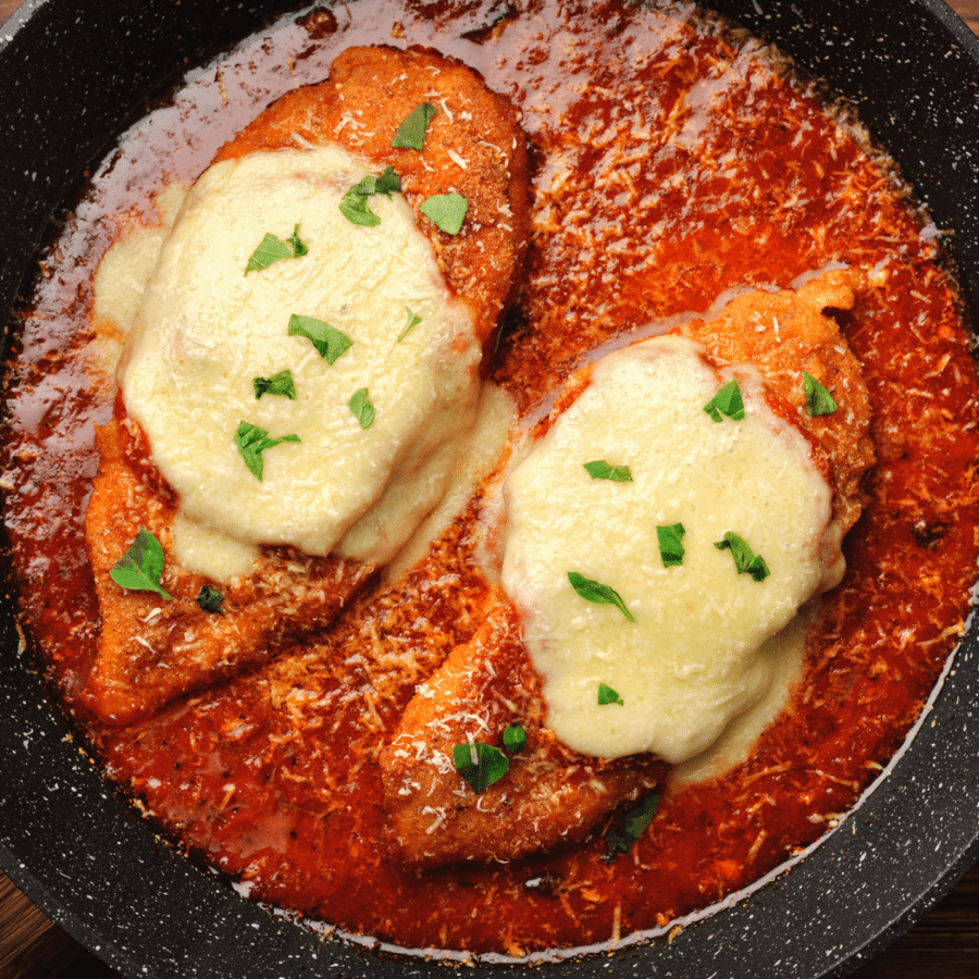 Overhead view of Keto Chicken Parmesan in a black serving plate