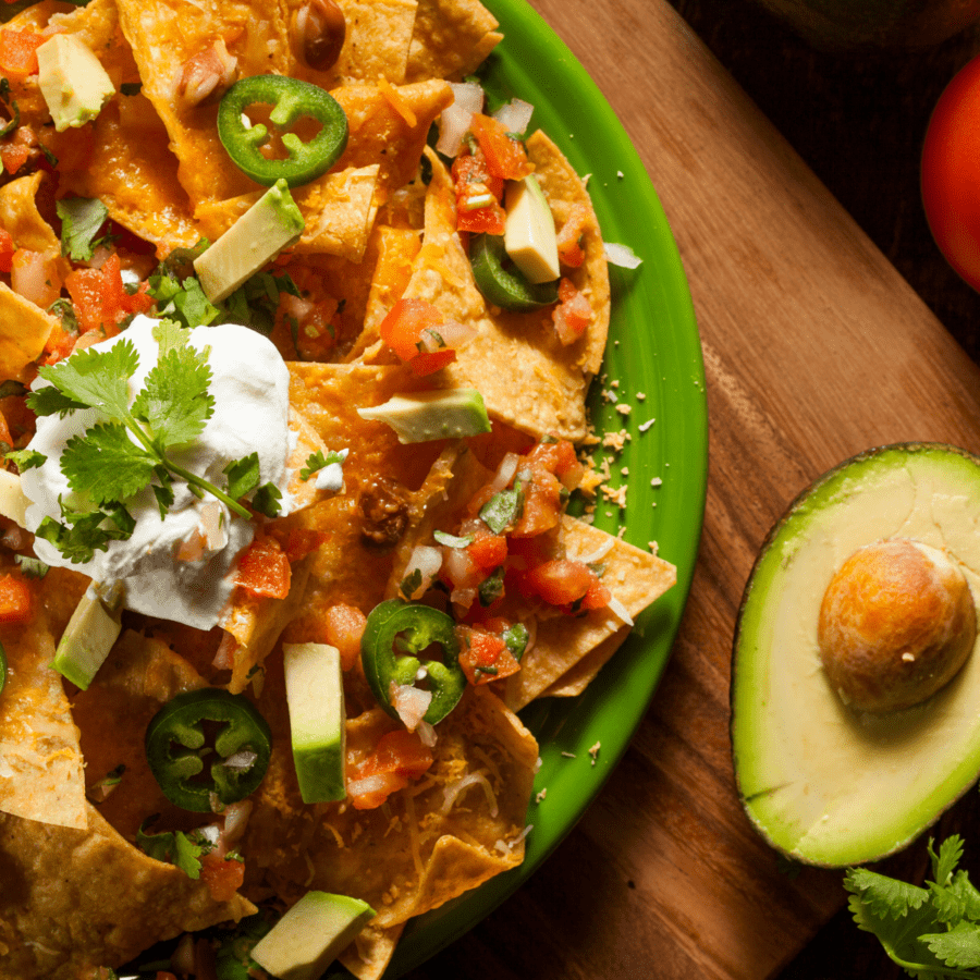Overhead image of air fryer nachos on a green plate