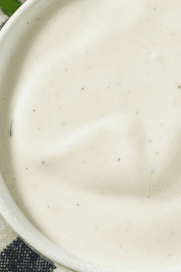 low carb ranch dressing in a white bowl on top of a striped towel