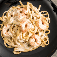 Overhead view of Cajun Shrimp Pasta on a black plate