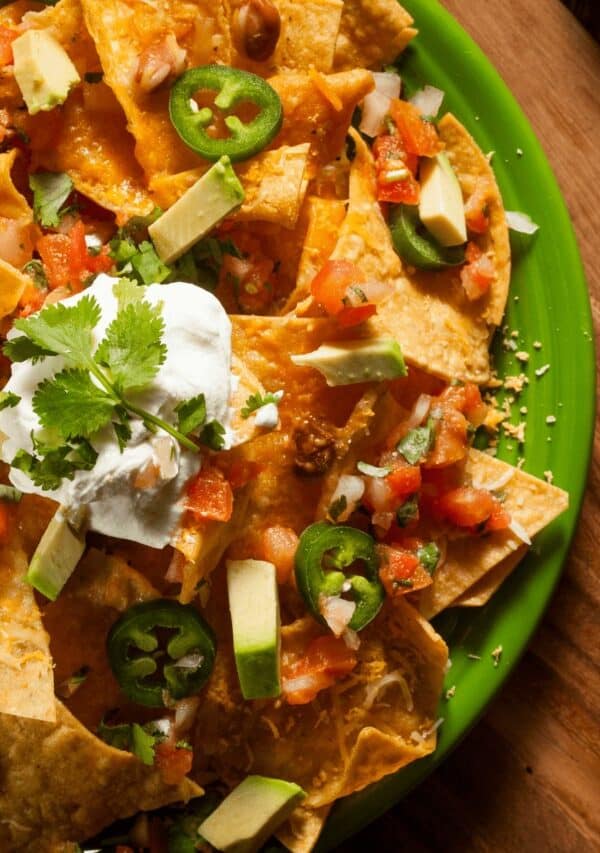 Overhead image of air fryer nachos on a green plate