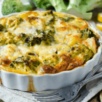 Broccoli Cauliflower Casserole in a white scalloped edge casserole dish