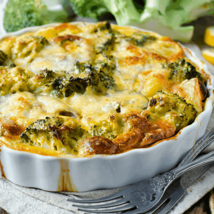 Broccoli Cauliflower Casserole in a white scalloped edge casserole dish