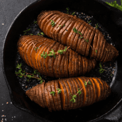Hasselback Sweet Potatoes in a cast iron skillet