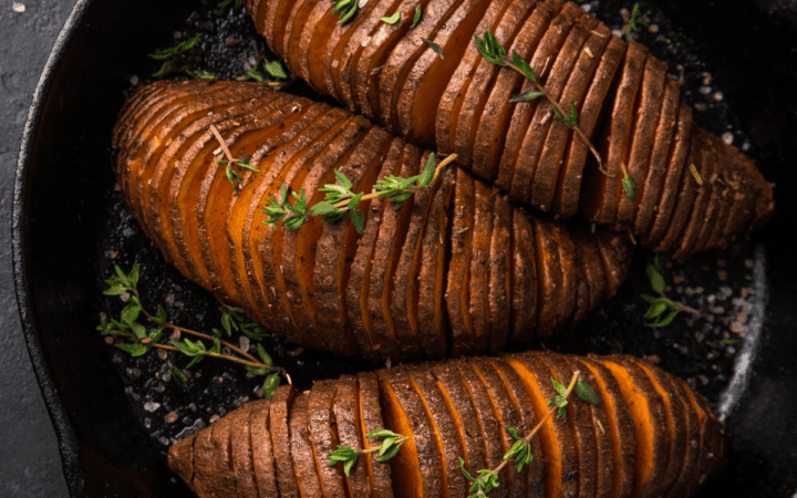 Hasselback Sweet Potatoes in a cast iron skillet