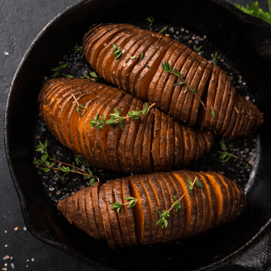 Hasselback Sweet Potatoes in a cast iron skillet