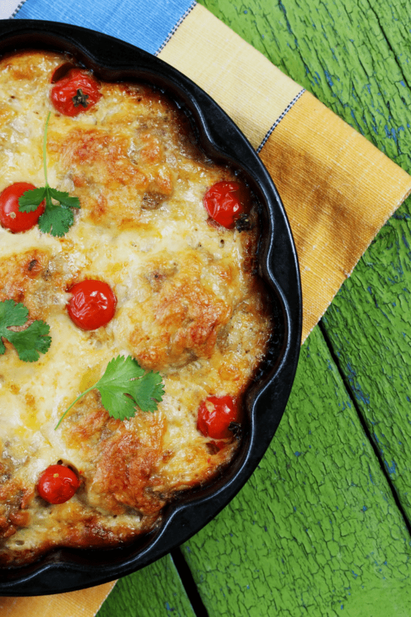 Meatball Casserole in a pan resting on a green background