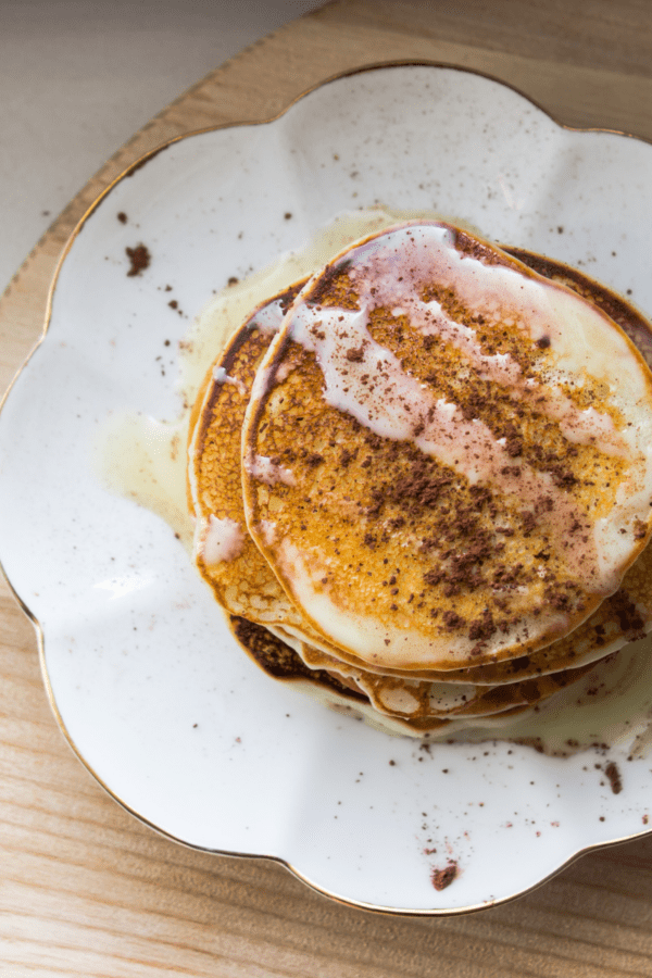 Overhead image of a stack of protein pancakes on a white plate