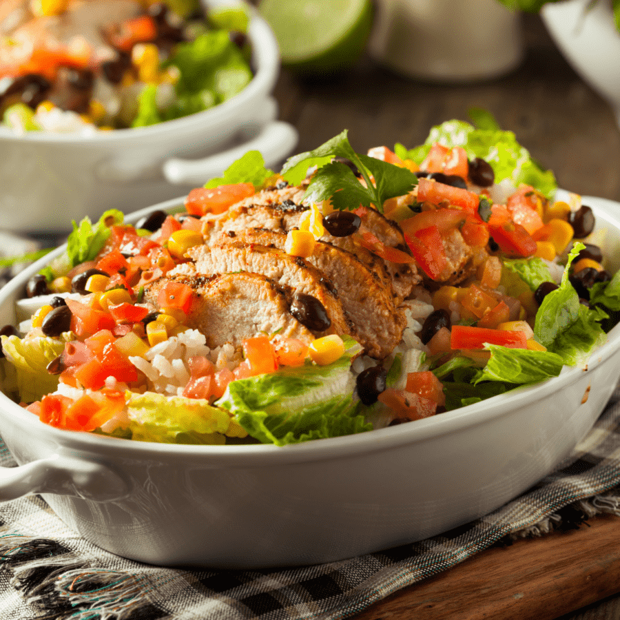 Closeup shot of a copycat Chipotle Burrito Bowl Sitting on a checkered kitchen towel