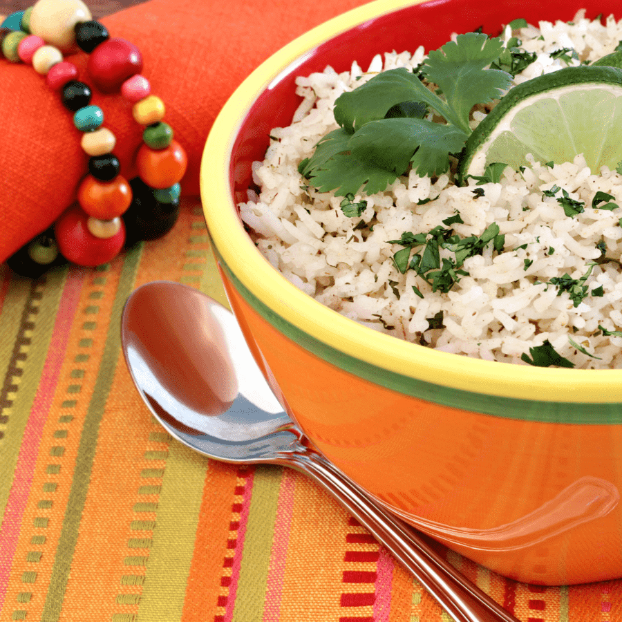 Chipotle CIlantro lime rice in an orange bowl with a spoon next to it