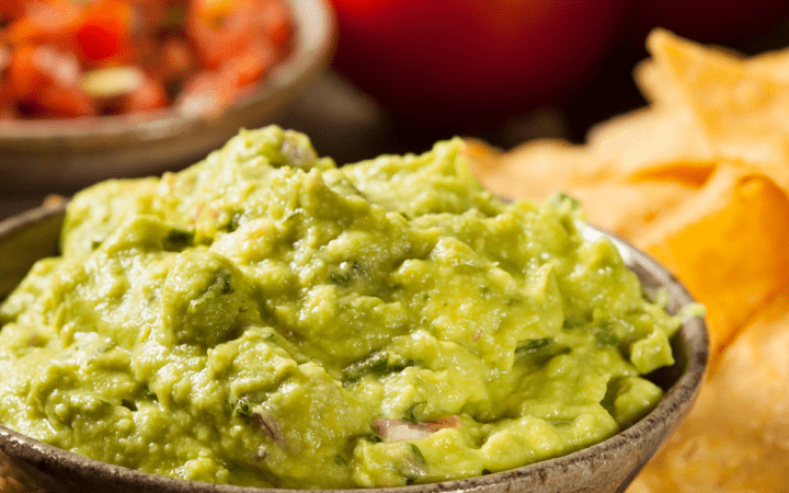 Chipotle Guacamole with chips and salsa surrounding it