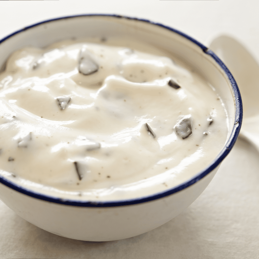 Cheesecake DIp in a white bowl with a navy rim